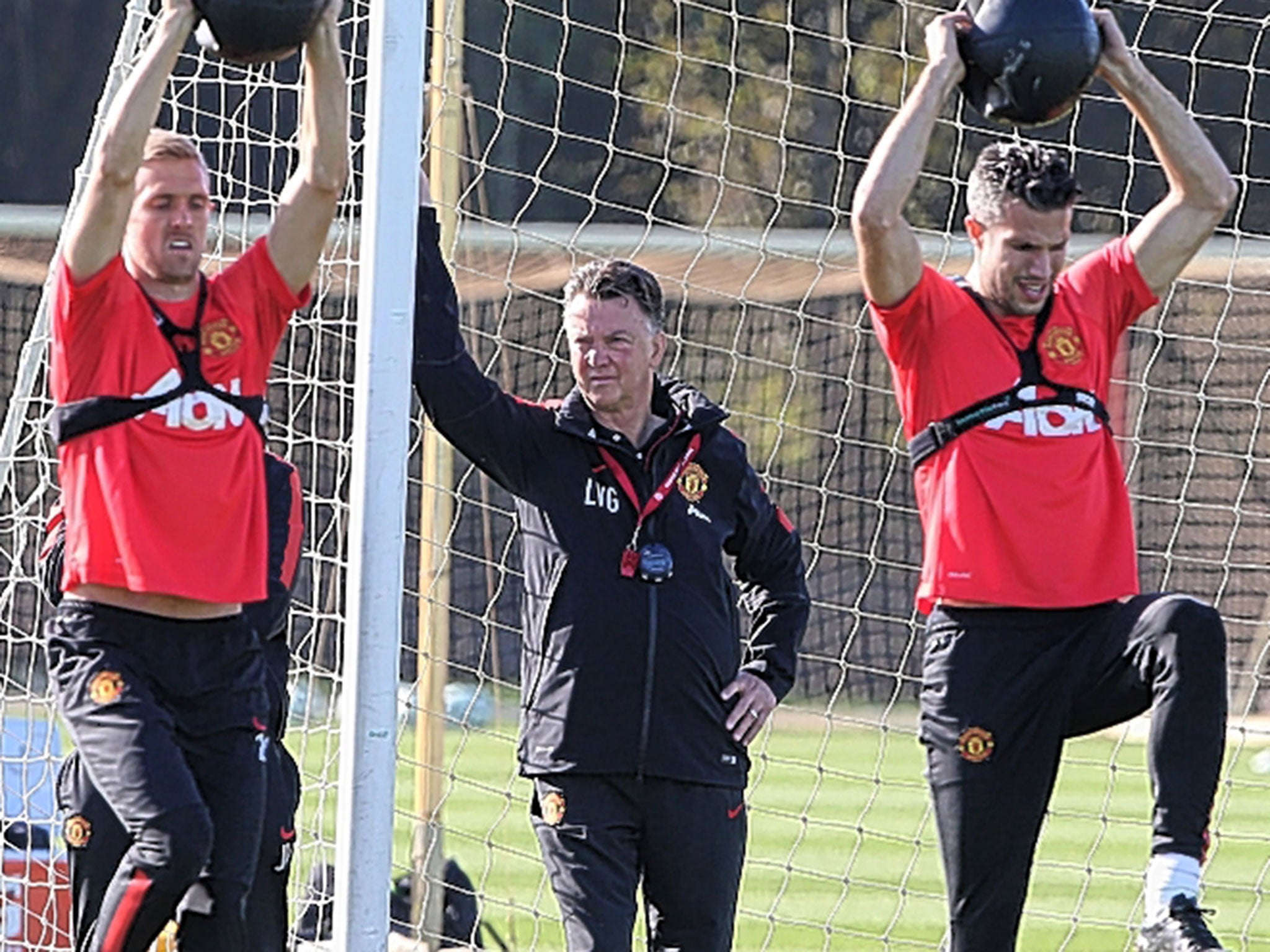 Louis van Gaal (centre) supervises training with Manchester United this week