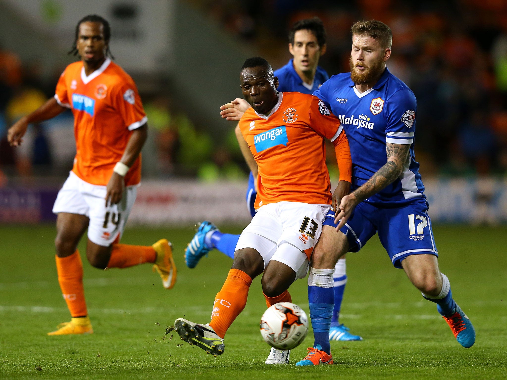 Francois Zoko of Blackpool is challenged by Aron Gunnarsson of Cardiff City