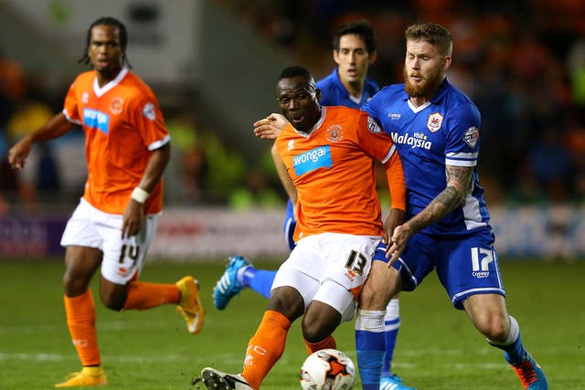 Francois Zoko of Blackpool is challenged by Aron Gunnarsson of Cardiff City