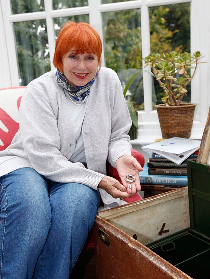 Jennifer Grant is pictured at her home holding the diamond jewellery she discovered inside the travelling case that once belonged to Agatha Christie's mother (Picture: Bonhams/EPA)