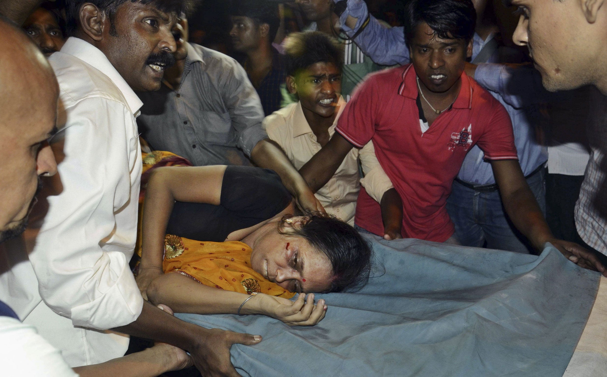 An Injured woman is carried on a stretcher to a hospital for treatment in Patna, India.