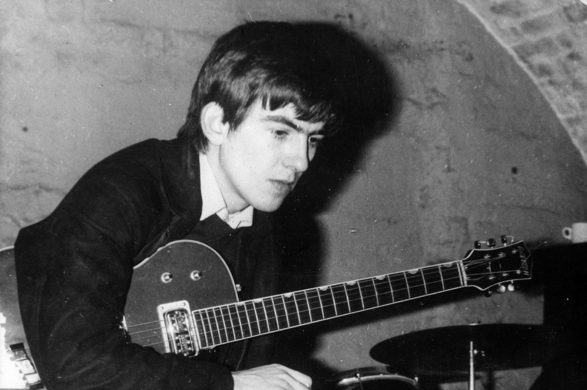 Circa 1960, a young George Harrison takes a break from playing at the Cavern, Liverpool