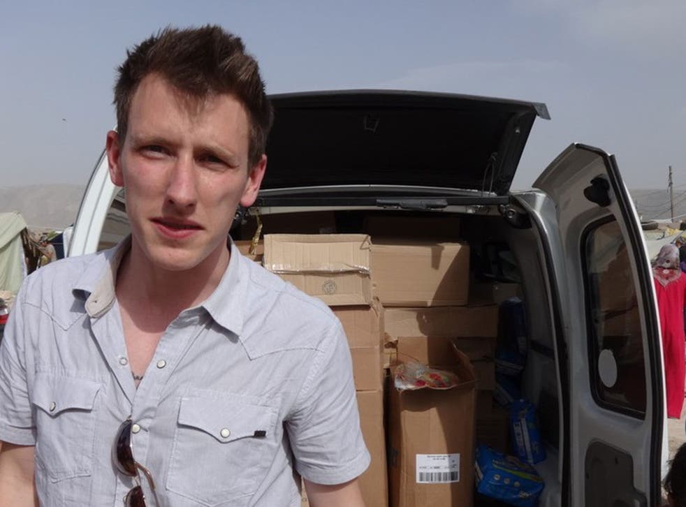 An undated photo provided by the Kassig Family shows Peter Kassig standing in front of a truck filled with supplies for Syrian refugees. 
