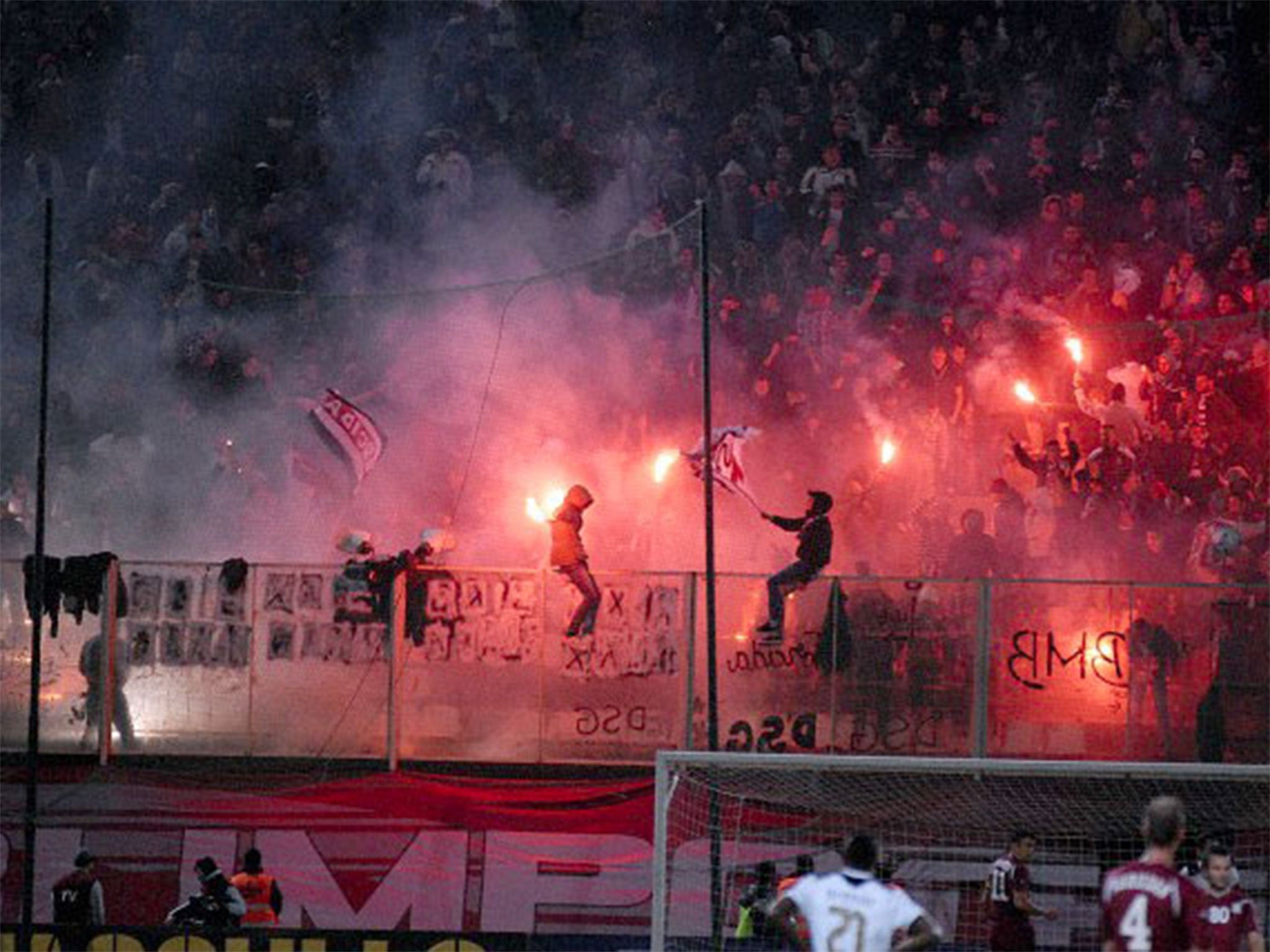 Rapid Bucharest fans with flares pictured on the terraces during a match with Astra Giurgiu in 2012