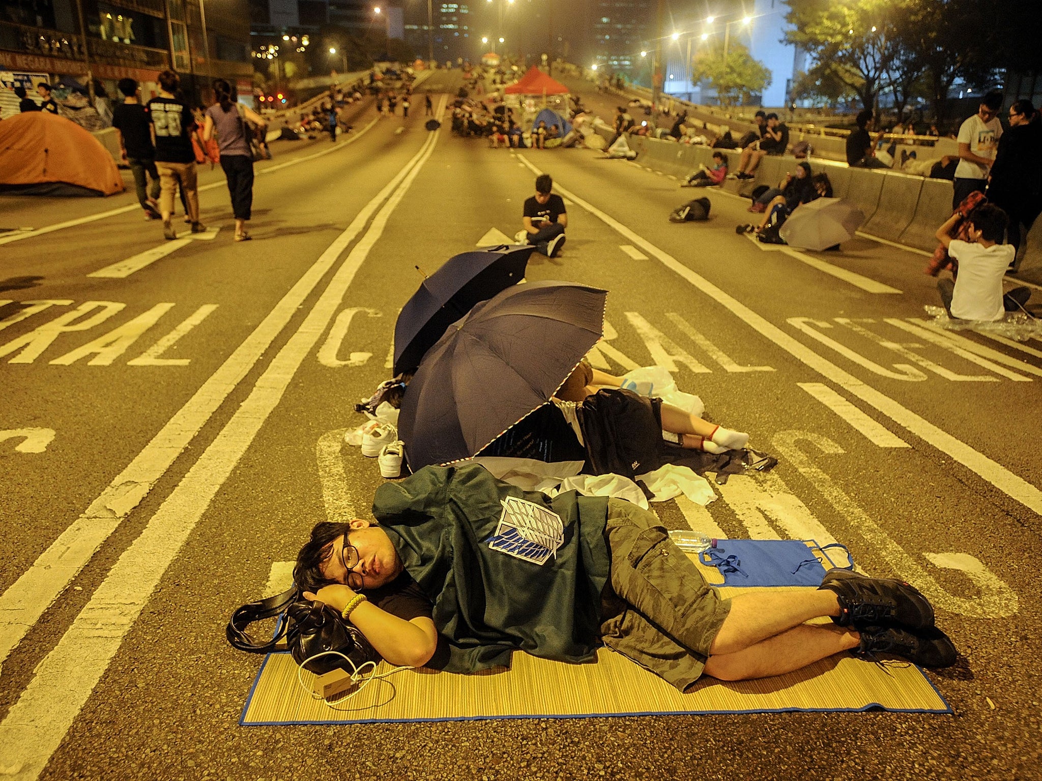 A protester sleeps in the street outside the Hong Kong
government building