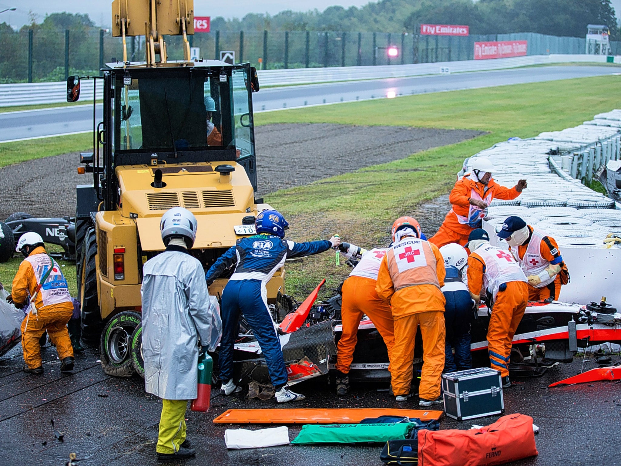 Jules Bianchi receiving treatment after smashing into the tractor (in background) that had been attending to Sauber driver Adrian Sutil’s earlier crash