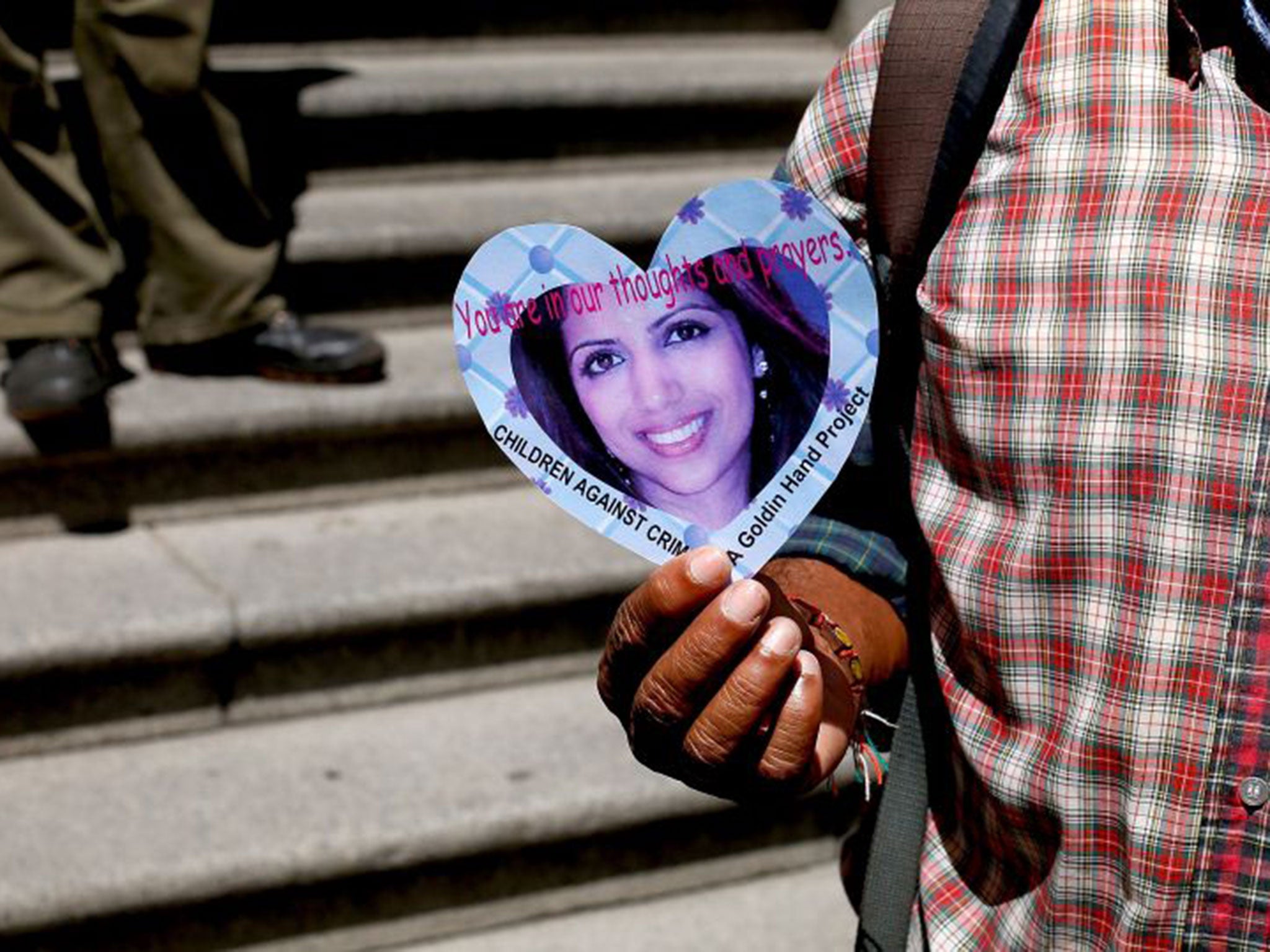 A protester holding up a picture of Anni Dewani outside the High Court.