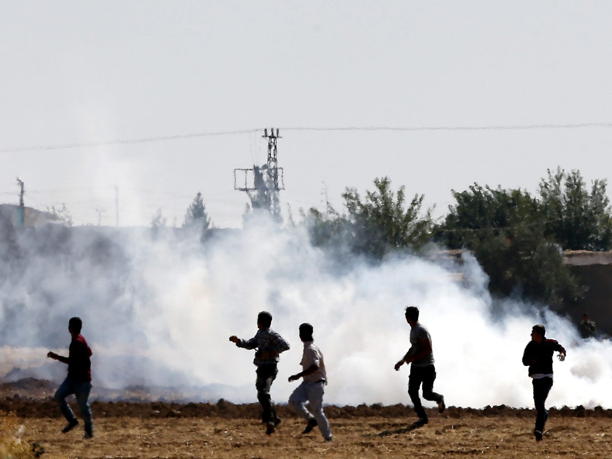 Turkish Gendarmerie use tear gas to disperse Kurdish protesters during a demonstration against the Isis, at the Syria-Turkey border near Sanliurfa