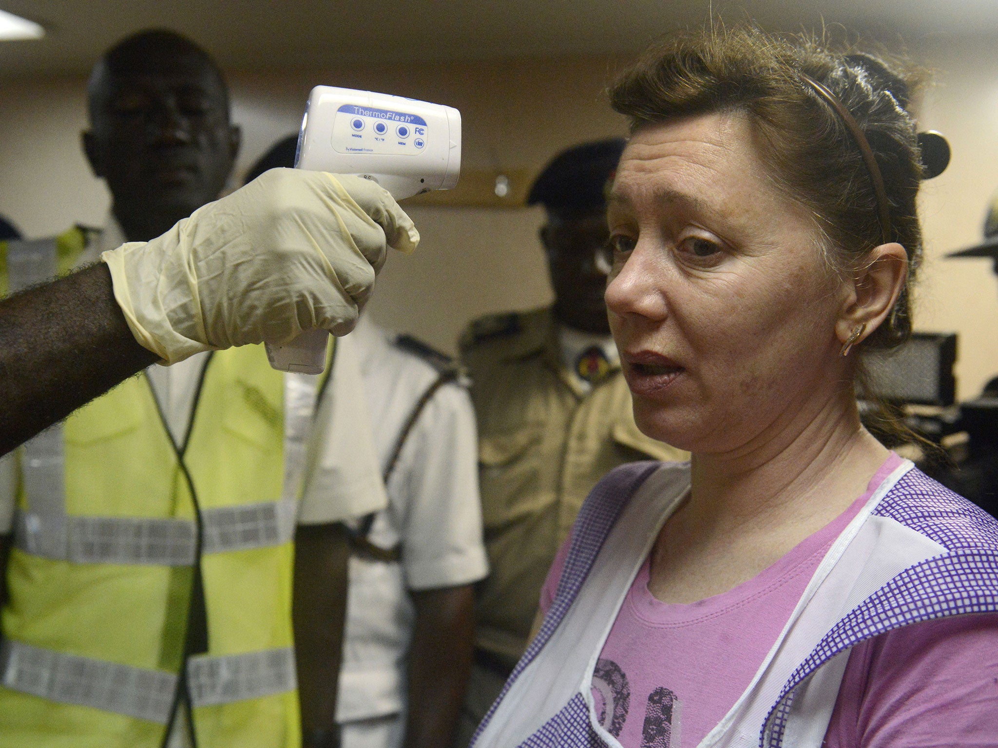 29 September 29 2014: A health official takes the body temperature of an Ukrainian worker on the MV Pintail cargo ship, as they check for signs of the Ebola virus at the Apapa Sea Port, in Lagos