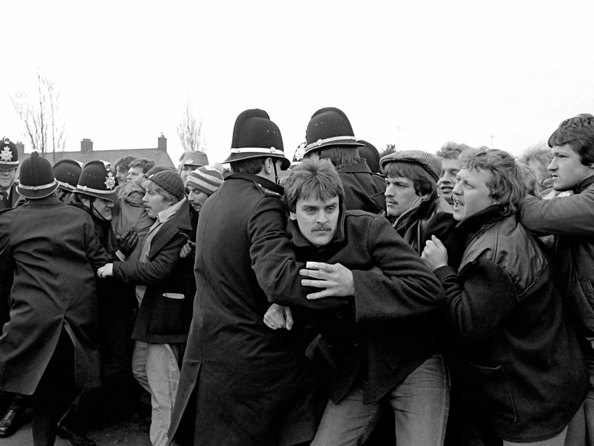 Coal not dole: striking workers are held back by police on the picket line at the Port Talbot Steelworks, South Wales in 1984