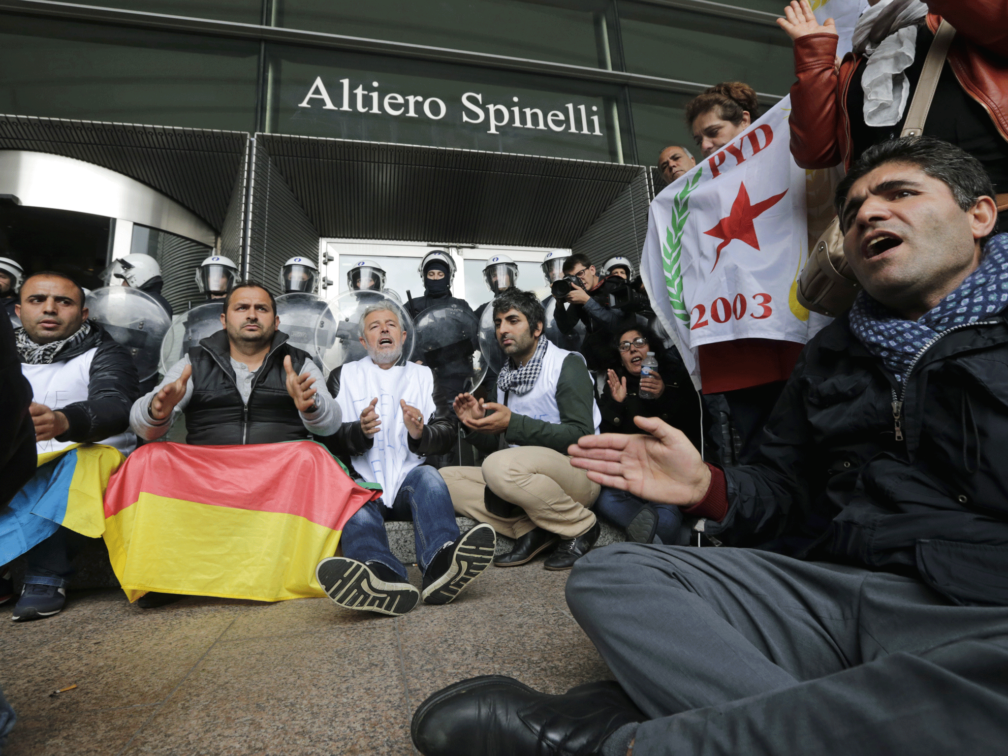 Riot police block Kurdish protesters as they gather in front of the entrance of the European Parliament in Brussels