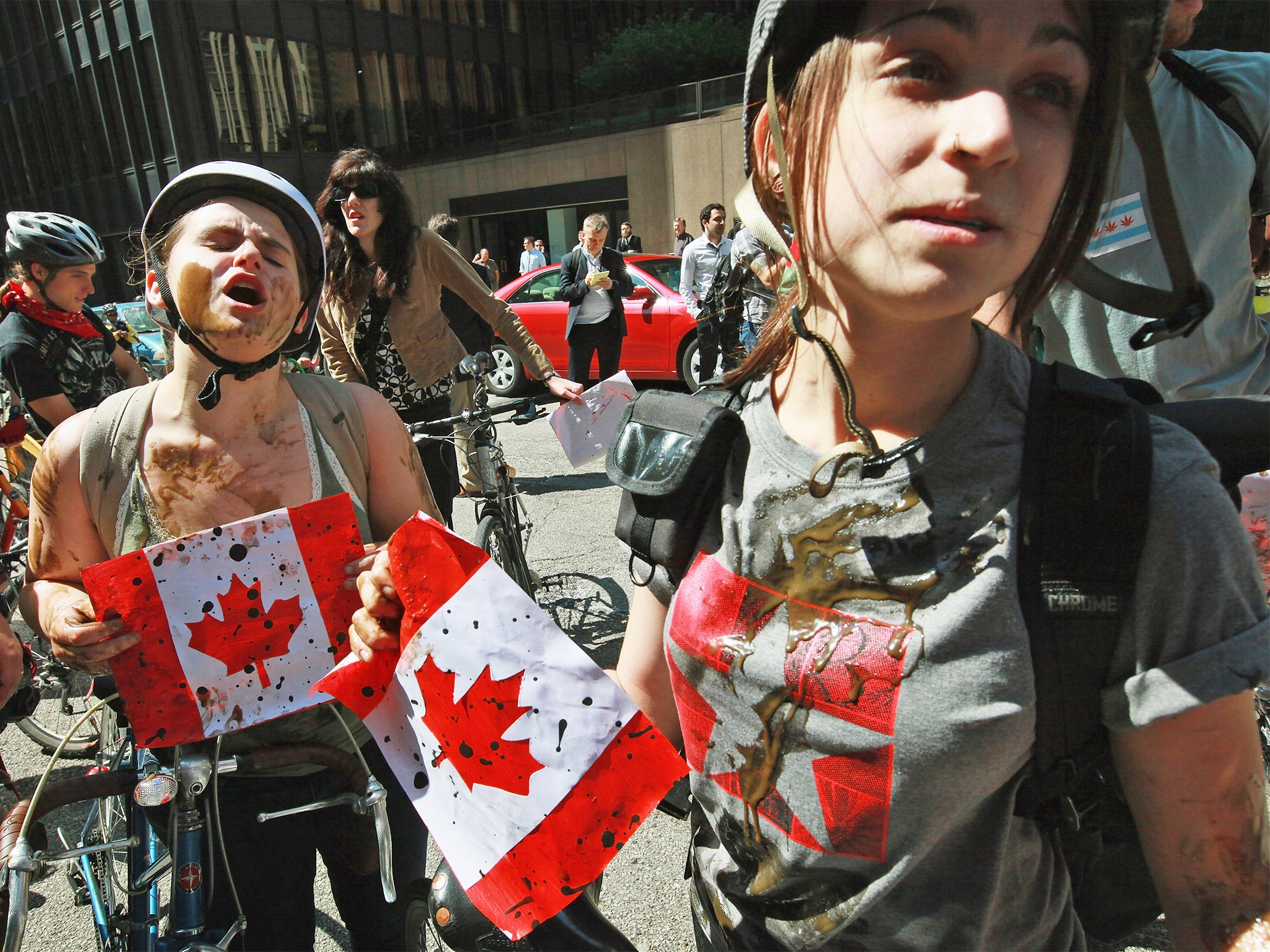 Demonstrators covered in oil protest against Canadian tar sands last year