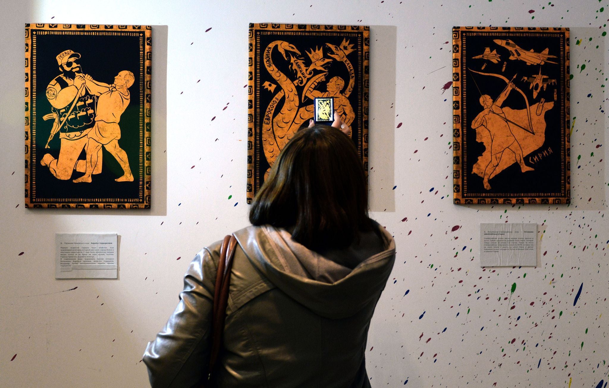 People visit the '12 Labours of Putin' art exhibition marking the 62th birthday of Russia's President Vladimir Putin