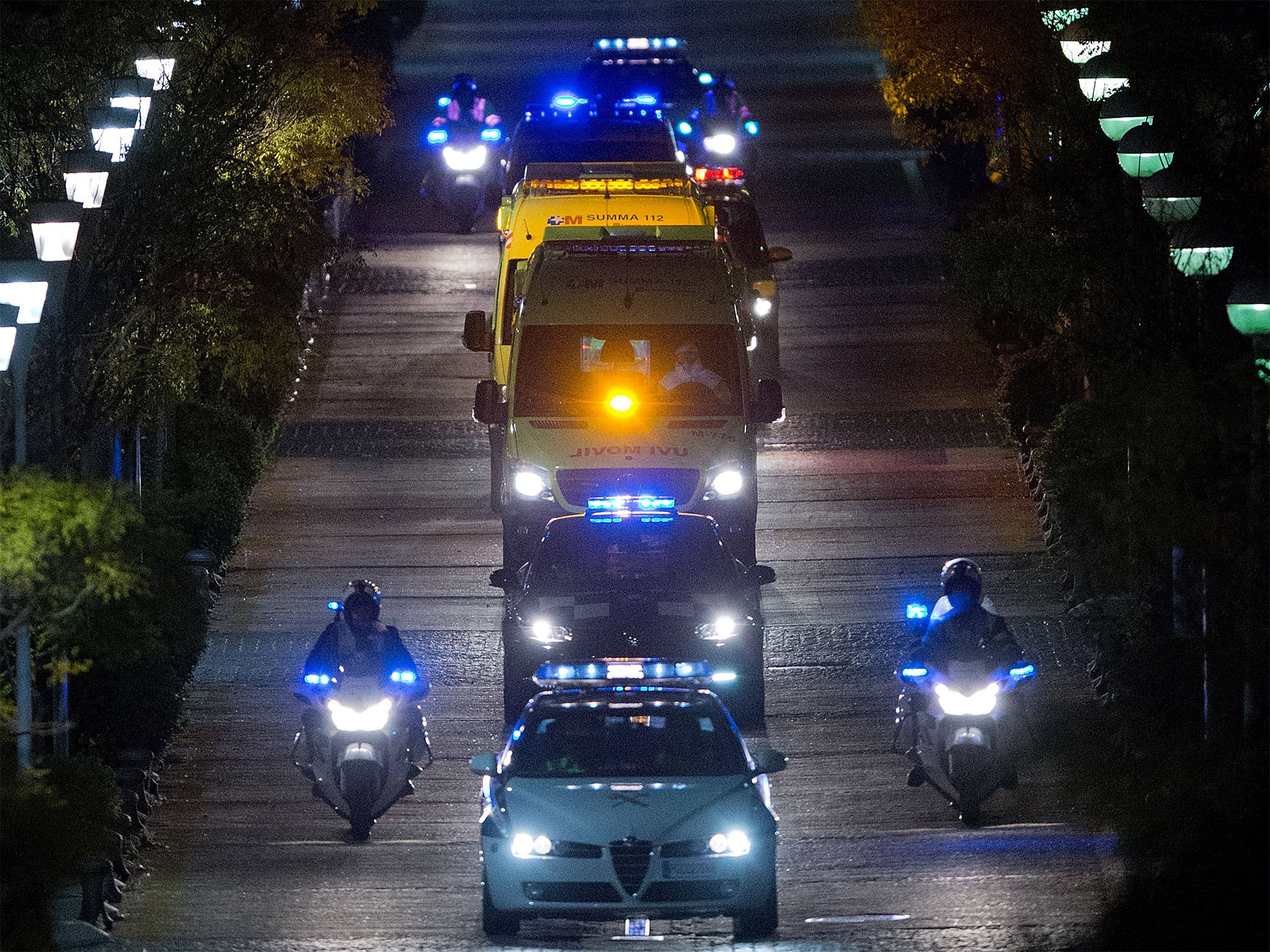 Police escort an ambulance carrying the Spanish nurse infected with Ebola to Carlos III hospital in Madrid