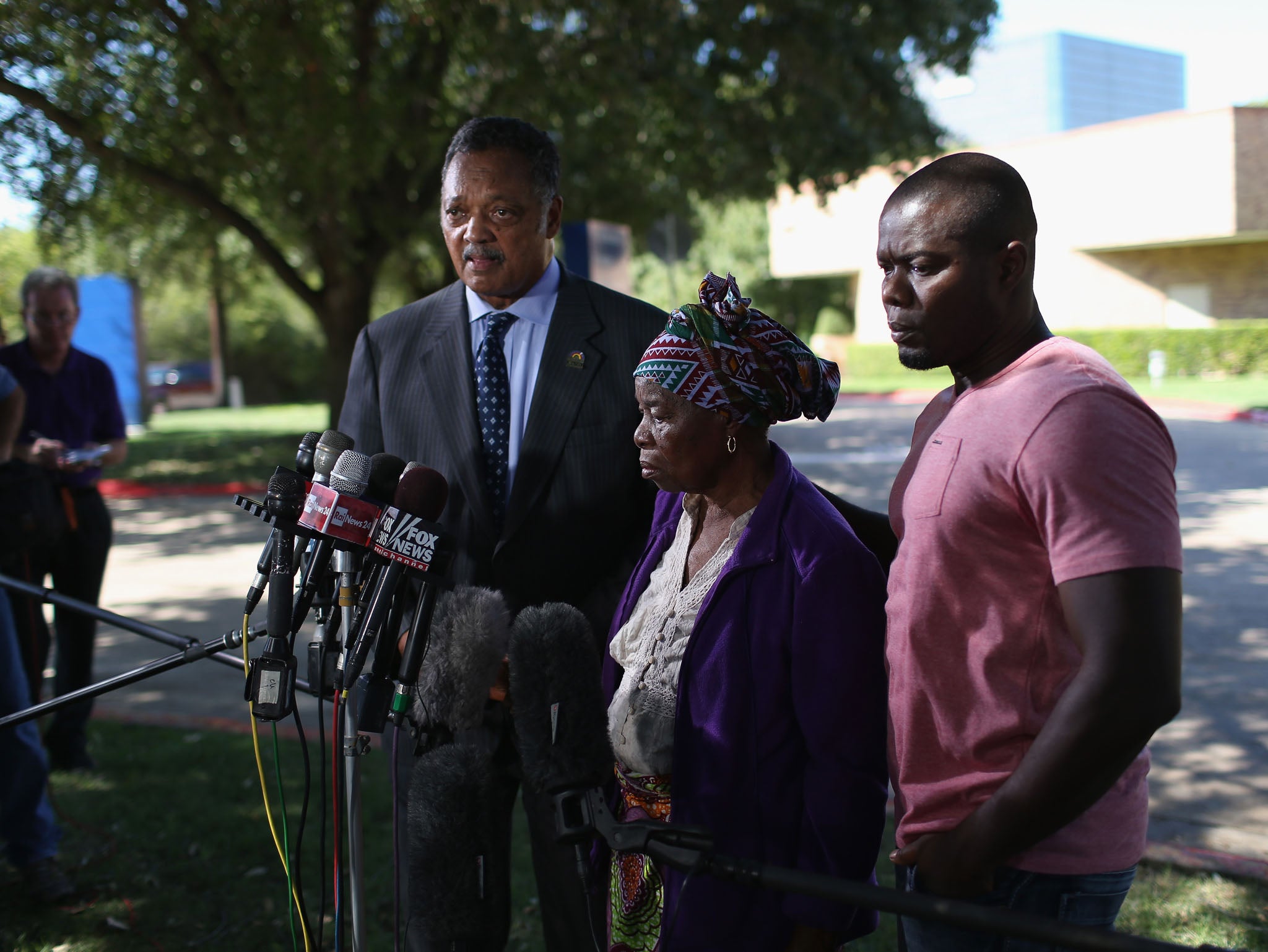 Rev. Jesse Jackson (L) stands with Nowai korkoyah (C) the mother of Ebola patient Thomas Eric Duncan, as well as his nephew, Josephus Weeks