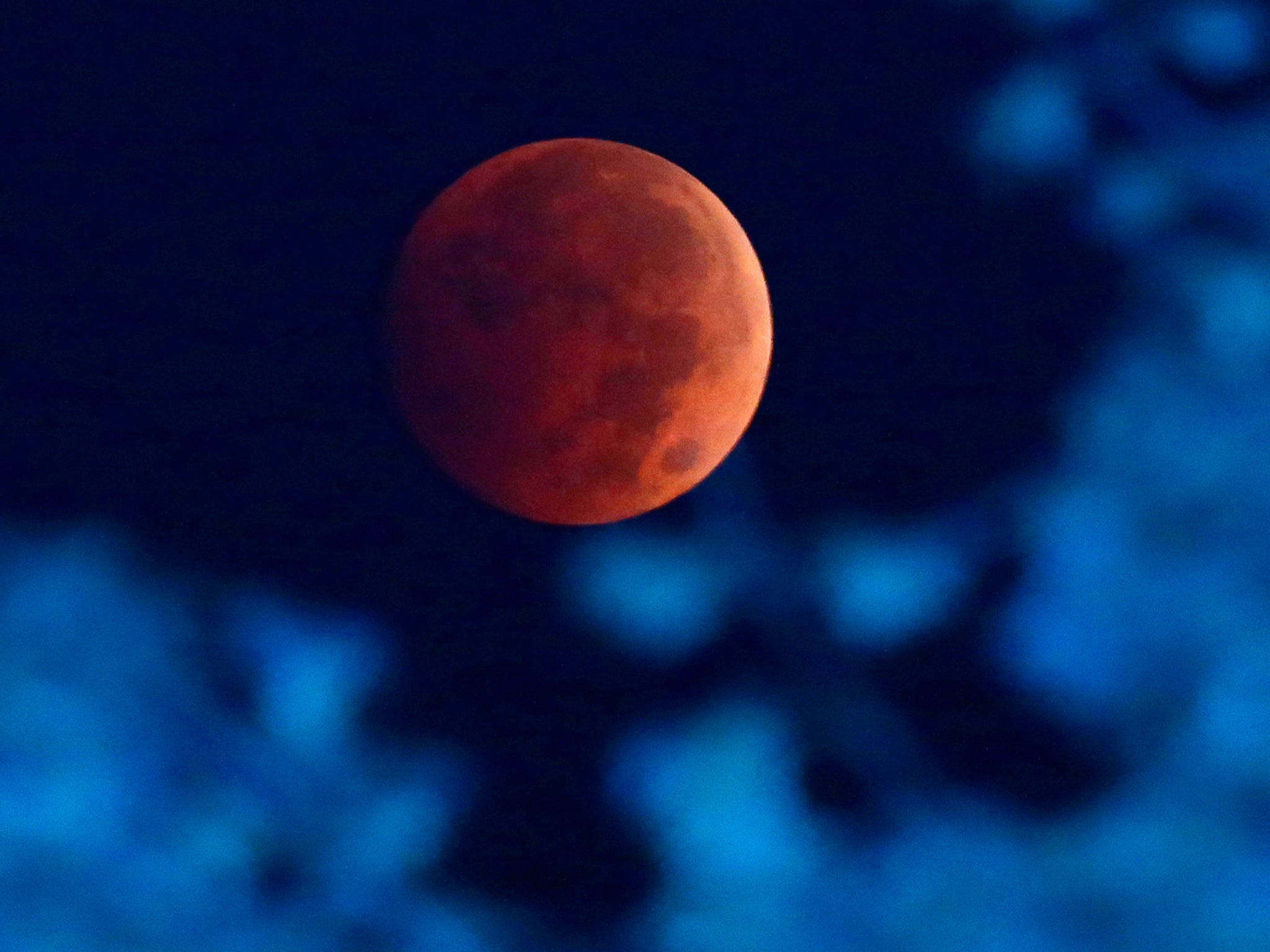 The Earth's shadow renders the moon during a total lunar eclipse over Milwaukee, USA