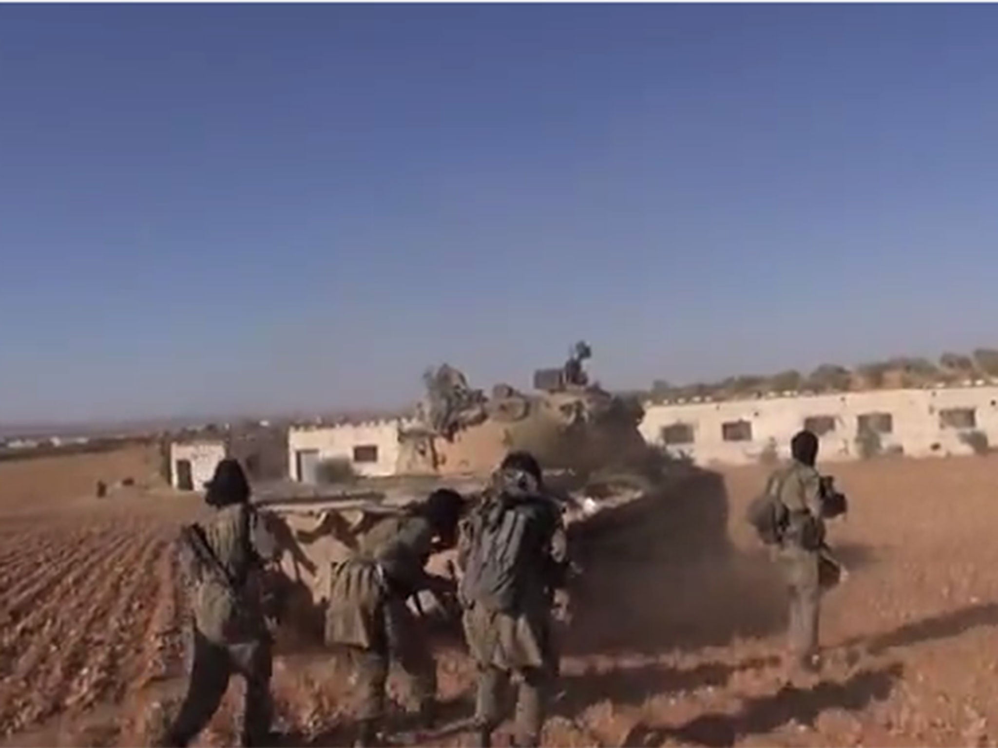Isis fighters firing on targets on the besieged Syria-Turkey border town of Kobani