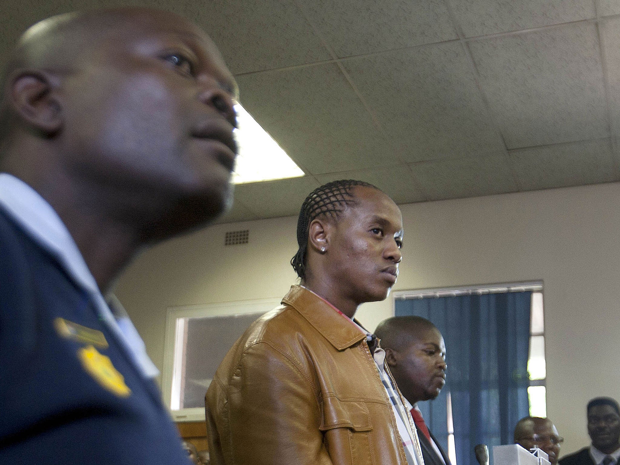 South African rapper Molemo 'Jub Jub' Maarohanye (centre) and his co-accused Themba Tshabalala (right) stand in court.