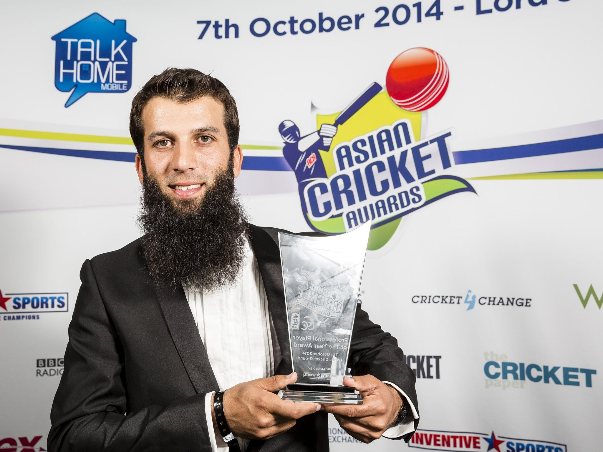 Moeen Ali, winner of the Professional Player of the Year award, poses with the trophy during the Asian Cricket Awards at Lord's