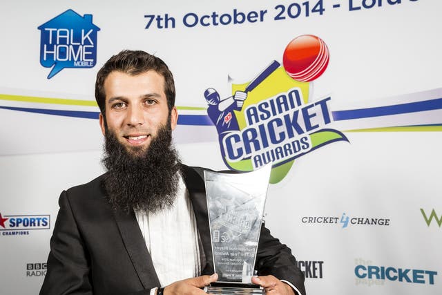 Moeen Ali, winner of the Professional Player of the Year award, poses with the trophy during the Asian Cricket Awards at Lord's