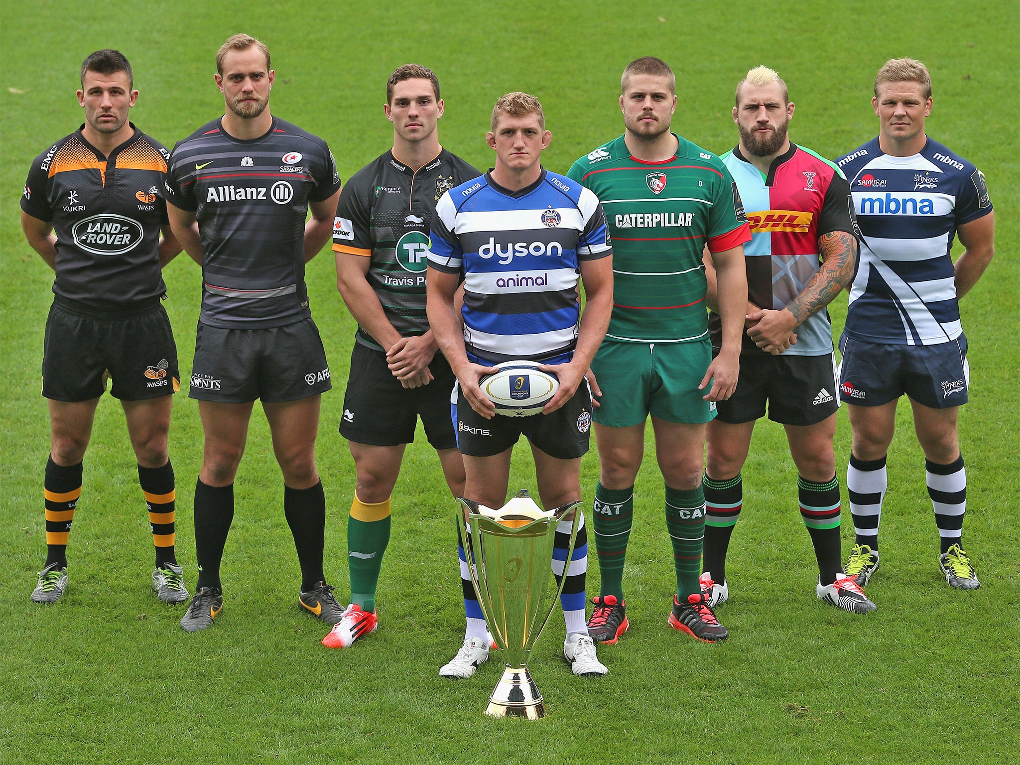 Left to right: Matt Mullan (Wasps), Alistair Hargreaves (Saracens), George North (Northamp-ton), Stuart Hooper (Bath), Ed Slater (Leicester), Joe Marler (Harlequins) and Dan Braid (Sale) pose with the European Rugby Champions Cup trophy