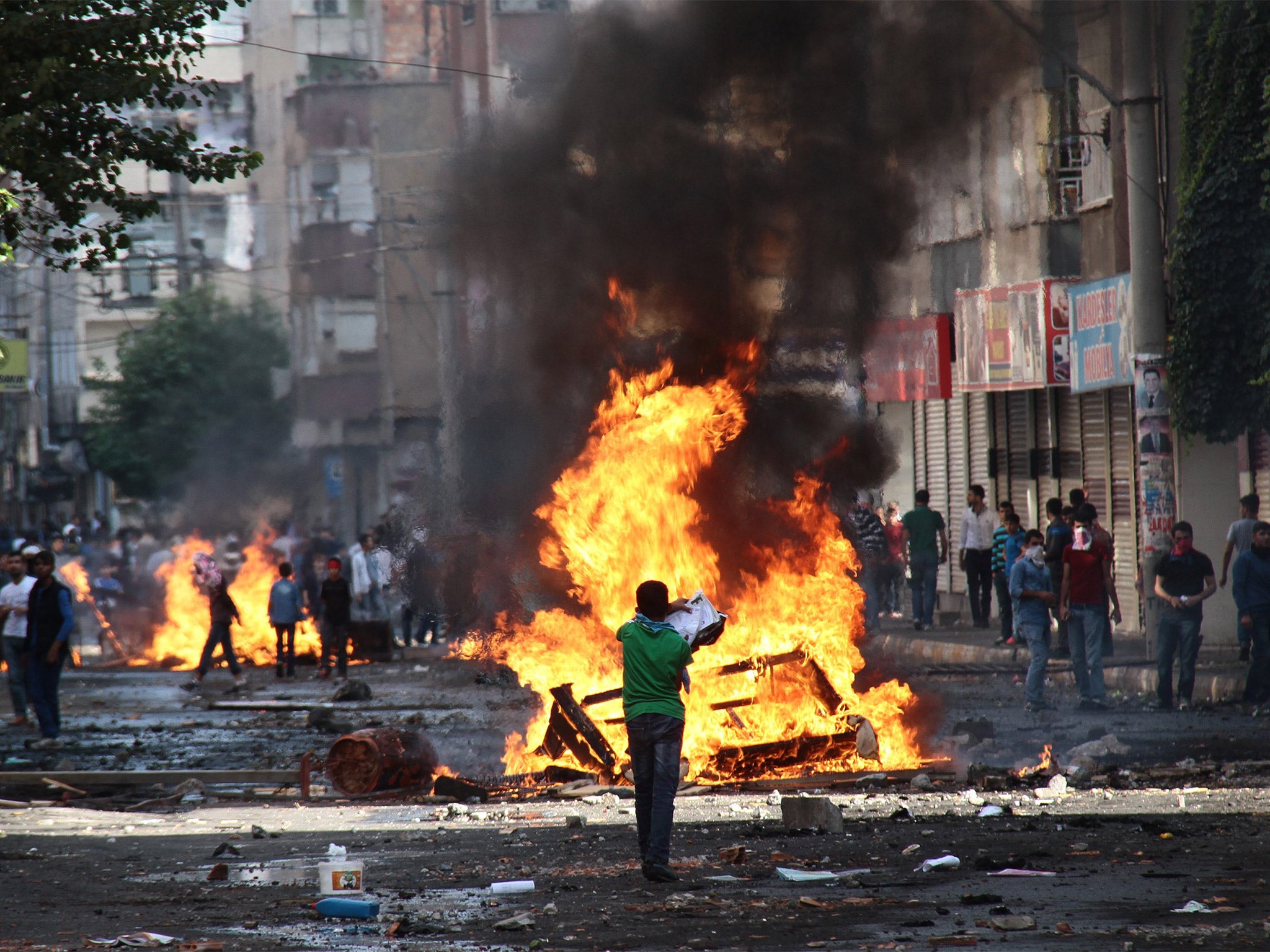 Kurdish protesters clashing with riot police during a demonstration in Diyarbakir, Turkey