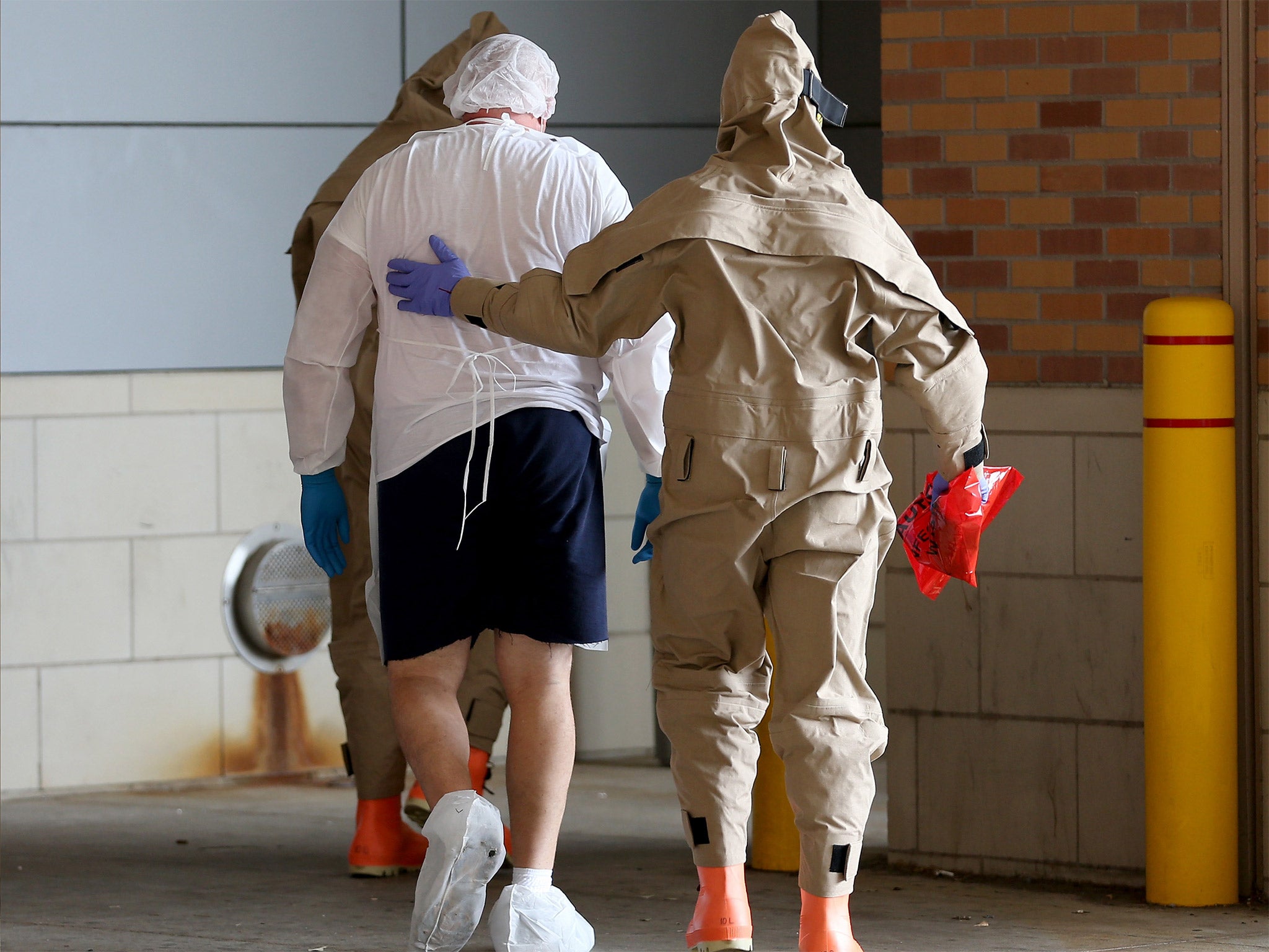 Michael Monnig is taken into the Texas Health Presbyterian Hospital, in Dallas (Getty)