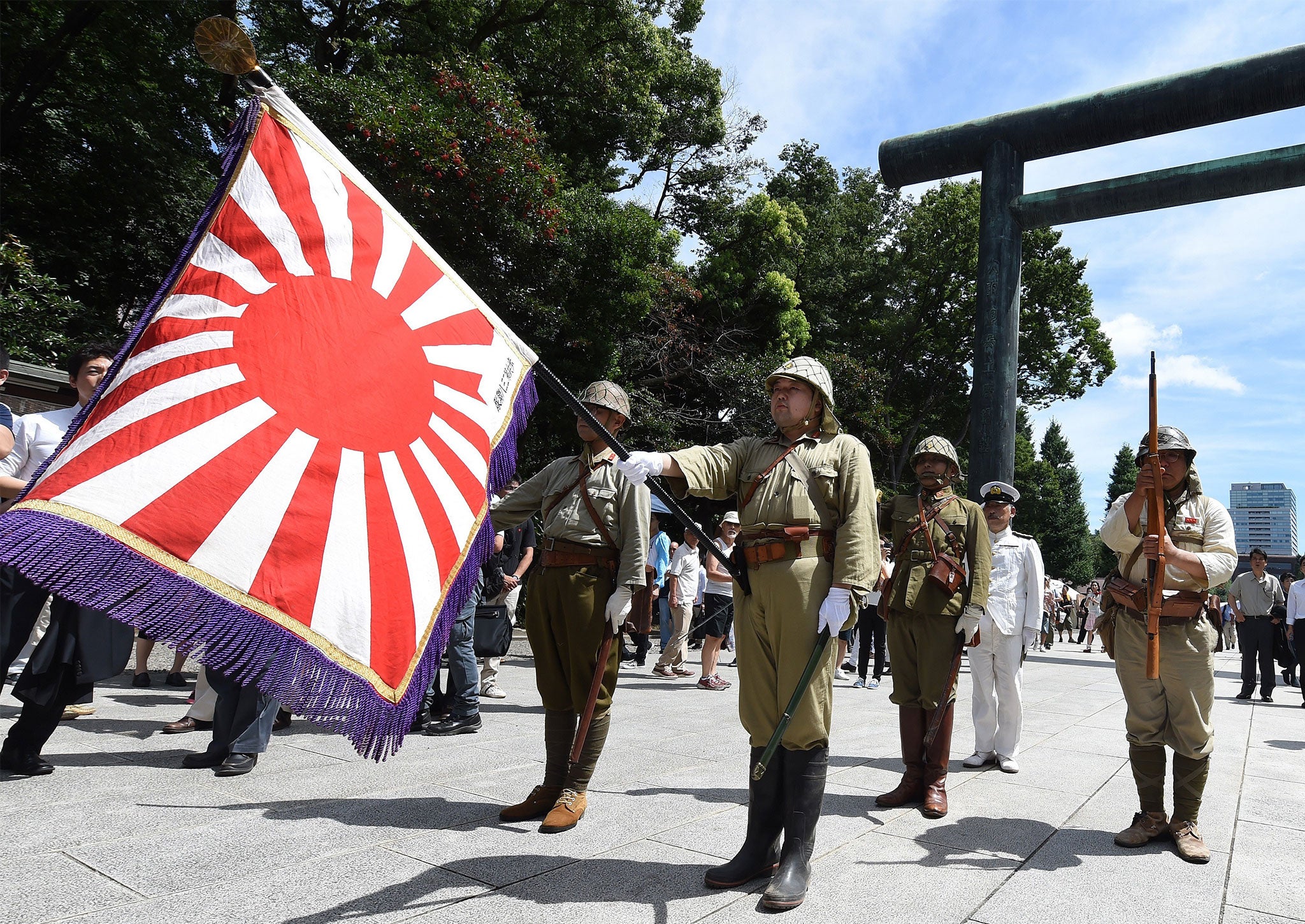 Japanese men parade around the controversial Yasukuni shrine, which remembers those who died in service of the Empire of Japan