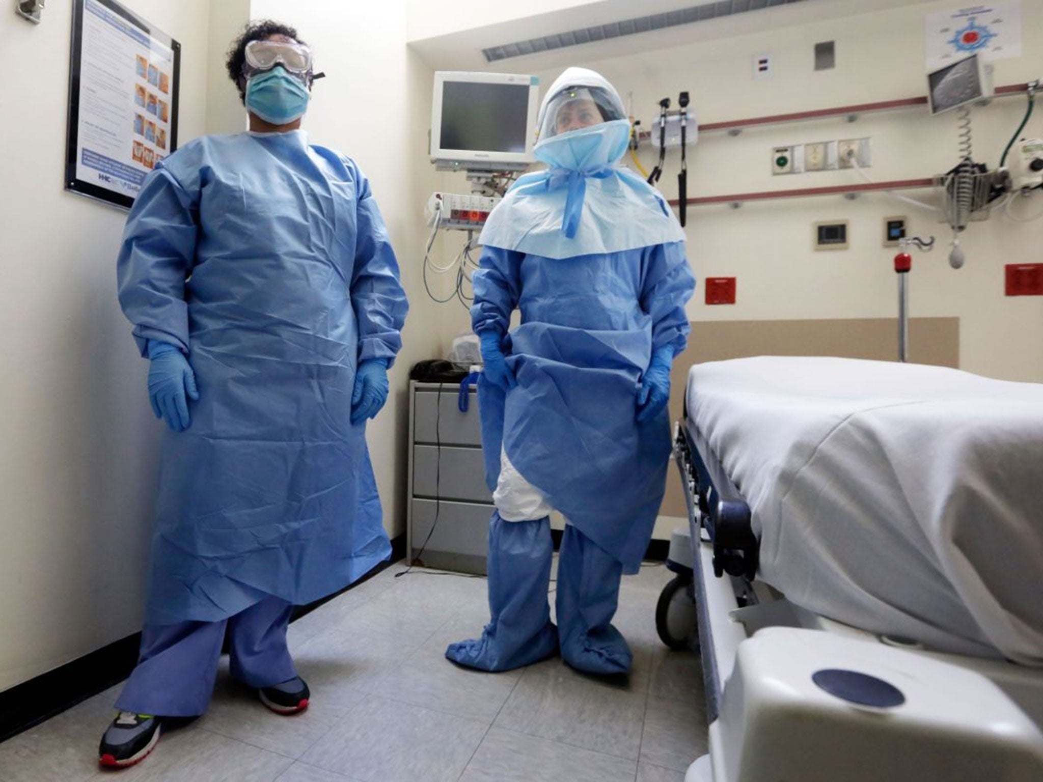 Ebola doctors wearing protective clothing in an emergency room.