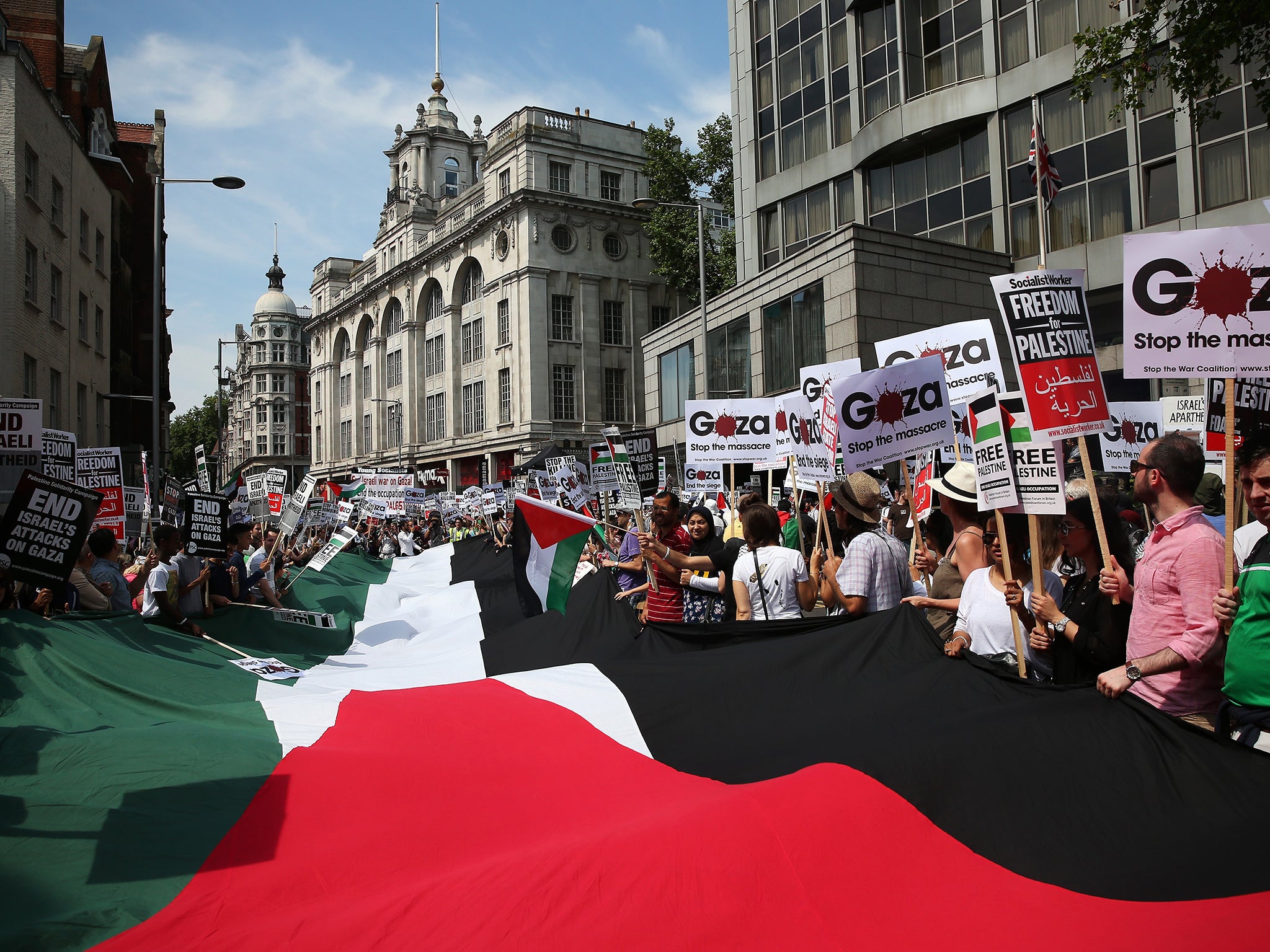 Protesters waving the Palestinian flag during a march
against the bombing of Gaza in London in July