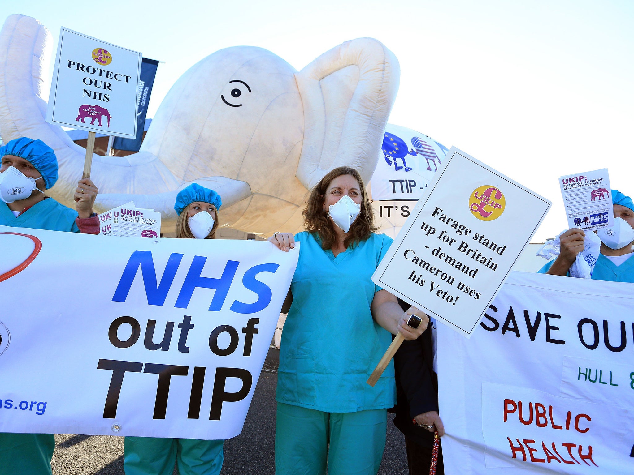 Health campaigners protest about the party's silence over the Transatlantic Trade and Investment Partnership (TTIP)