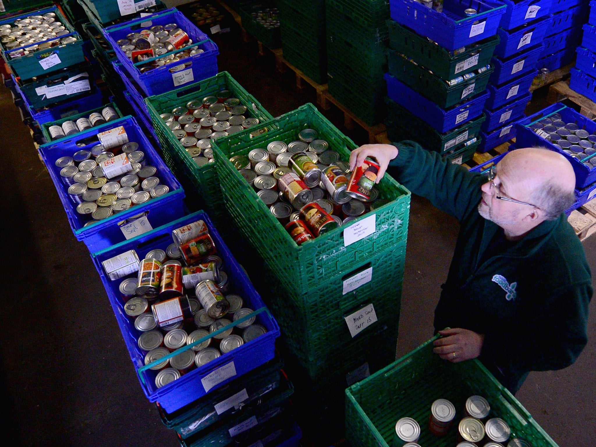 Alf Collington volunteer packs food at a food bank in Falkirk, Scotland