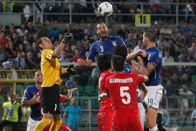 Giorgio Chiellini (centre) rises to score Italy’s opener
last night. The defender scored all three goals in their 2-1 win