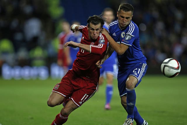 Gareth Bale vies with Bosnia and Herzegovina's midfielder Anel Hadzic 
