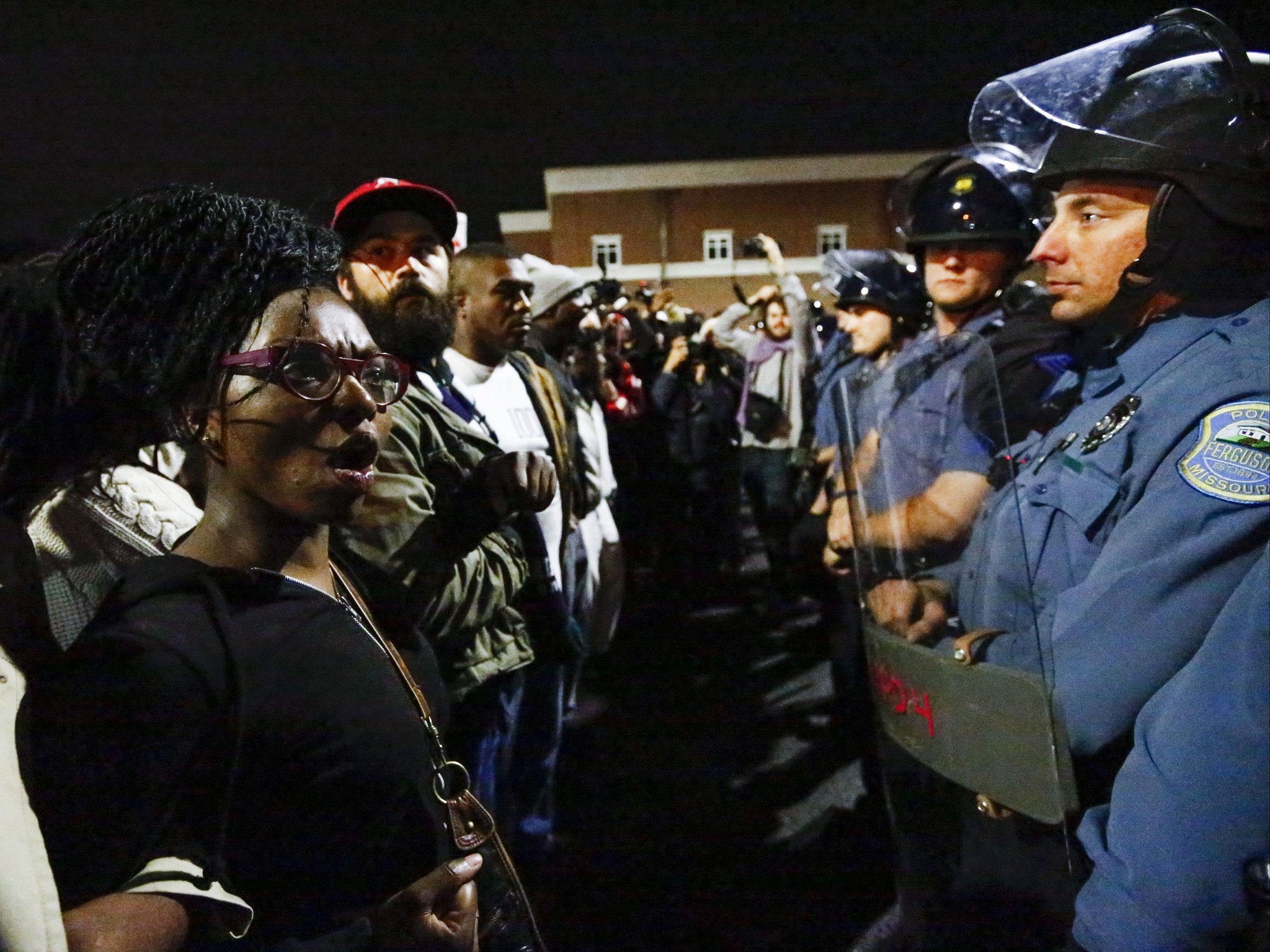 Protestors confront a police line as they march against the recent police shootings outside the Ferguson Police Department headquarters in Missouri