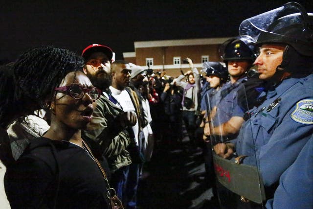 Protestors confront a police line as they march against the recent police shootings outside the Ferguson Police Department headquarters in Missouri  
