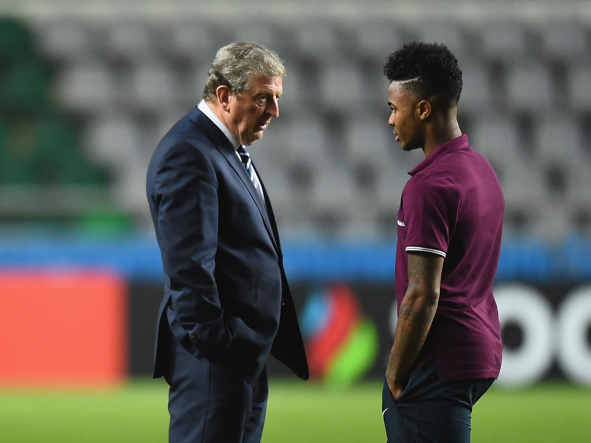 Roy Hodgson speaks to Raheem Sterling at the A. Le Coq stadium in Tallinn