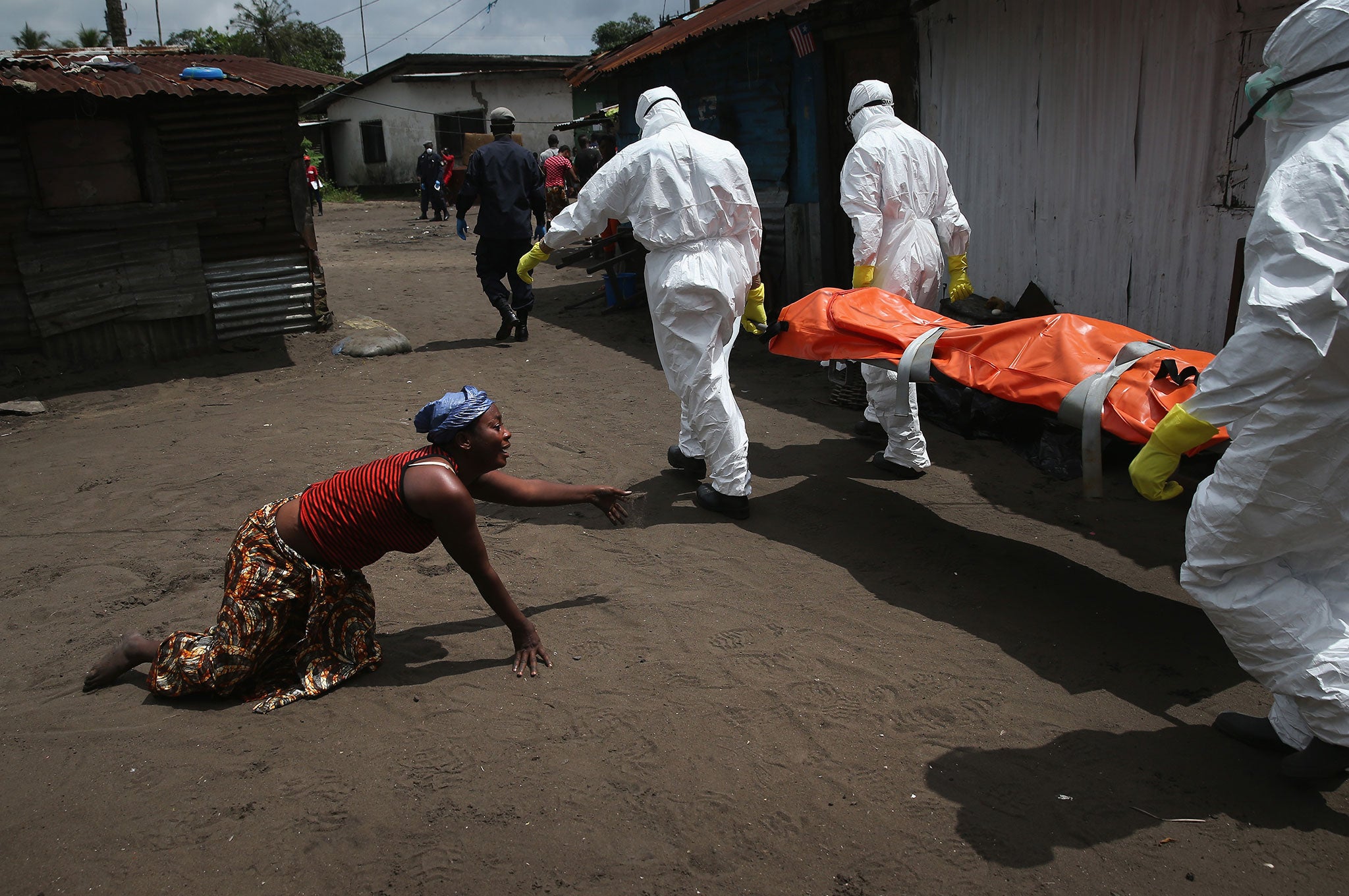 A woman mourns the death of her sister, who was killed by the Ebola virus