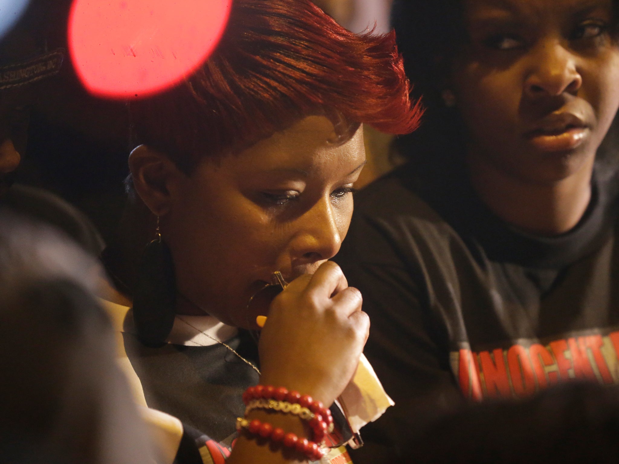 Lesley McSpadden pauses during the to look down at a memorial near her home at the place where her son was shot
