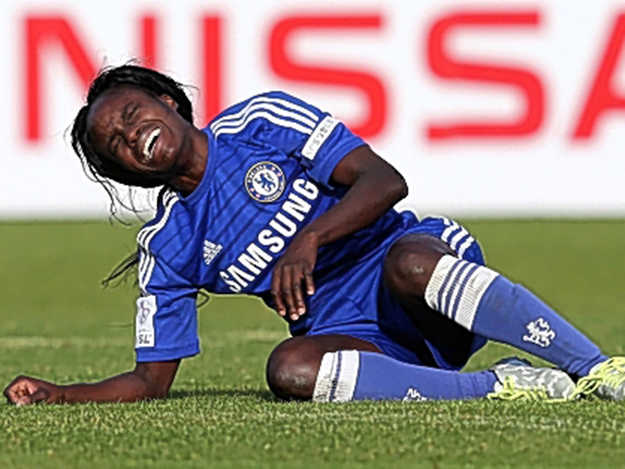 A devastated Eniola Aluko of Chelsea collapses in tears after the final whistle in Manchester