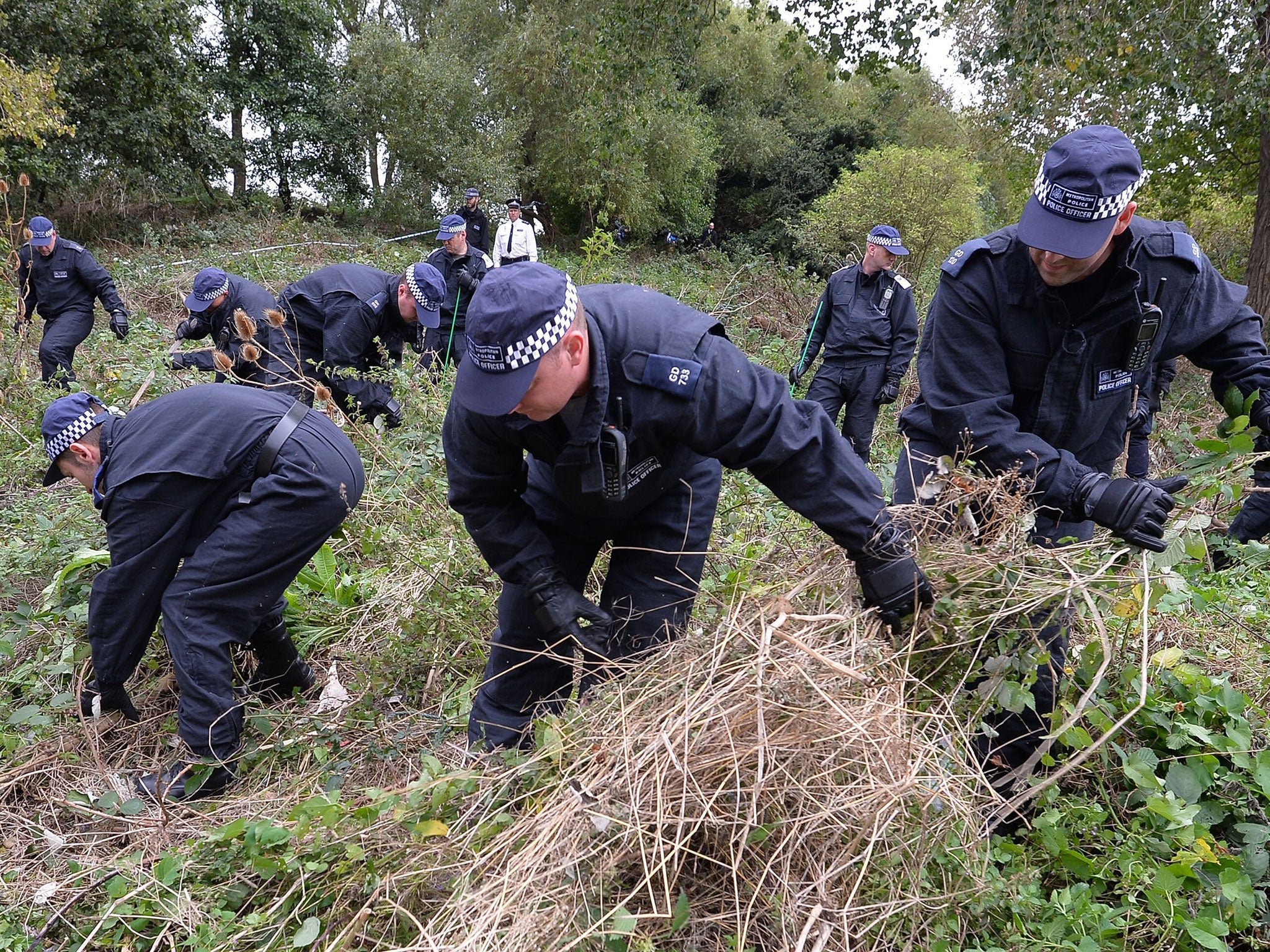 Police go over a section of wasteland near the river Brent in west London during the search for Alice Gross