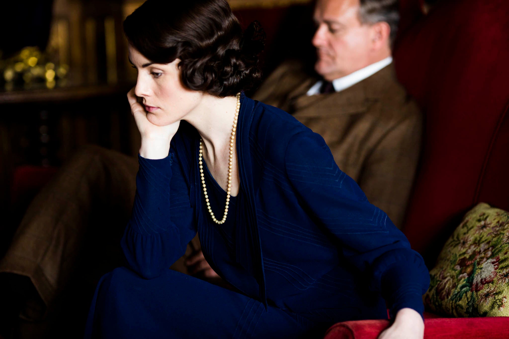 A sullen Lady Mary sits next to her father Robert, Earl of Grantham