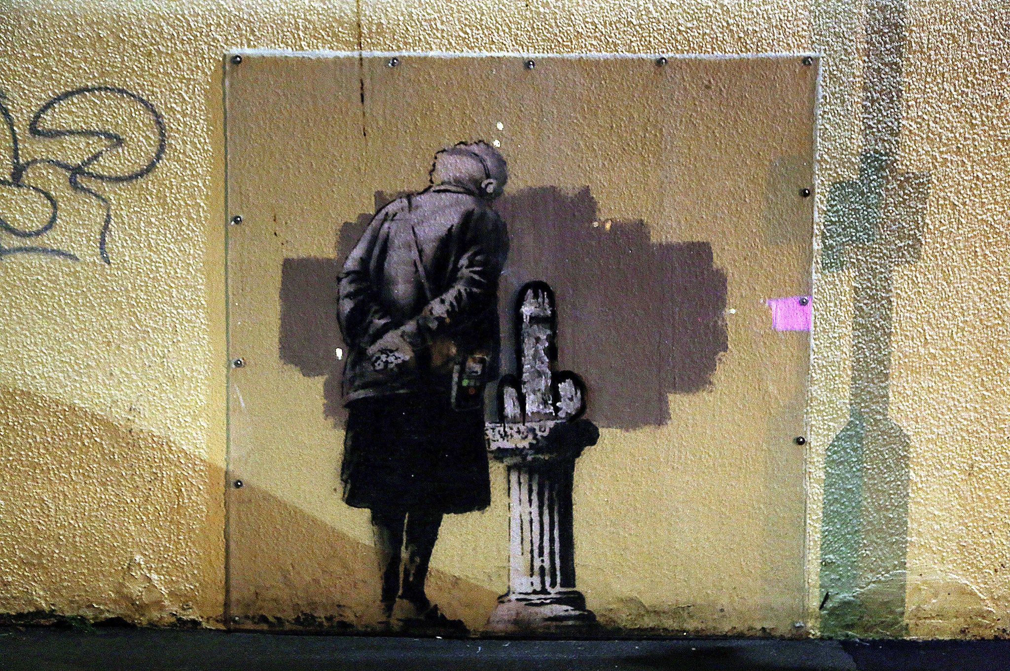 The Banksy image in Folkestone, with additional graffiti