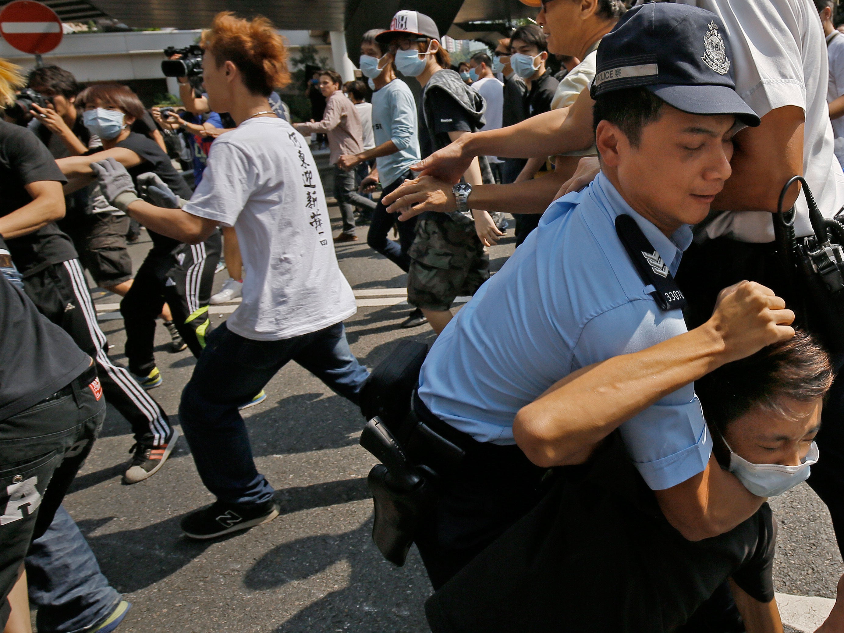 Police have been holding back angry crowds attempting to pull down protesters' barricades