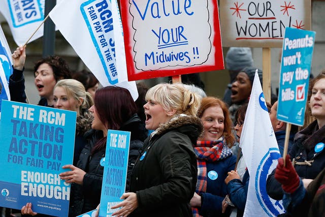 Midwives shout as they stand on a picket line outside St Mary's Hospital in Manchester 