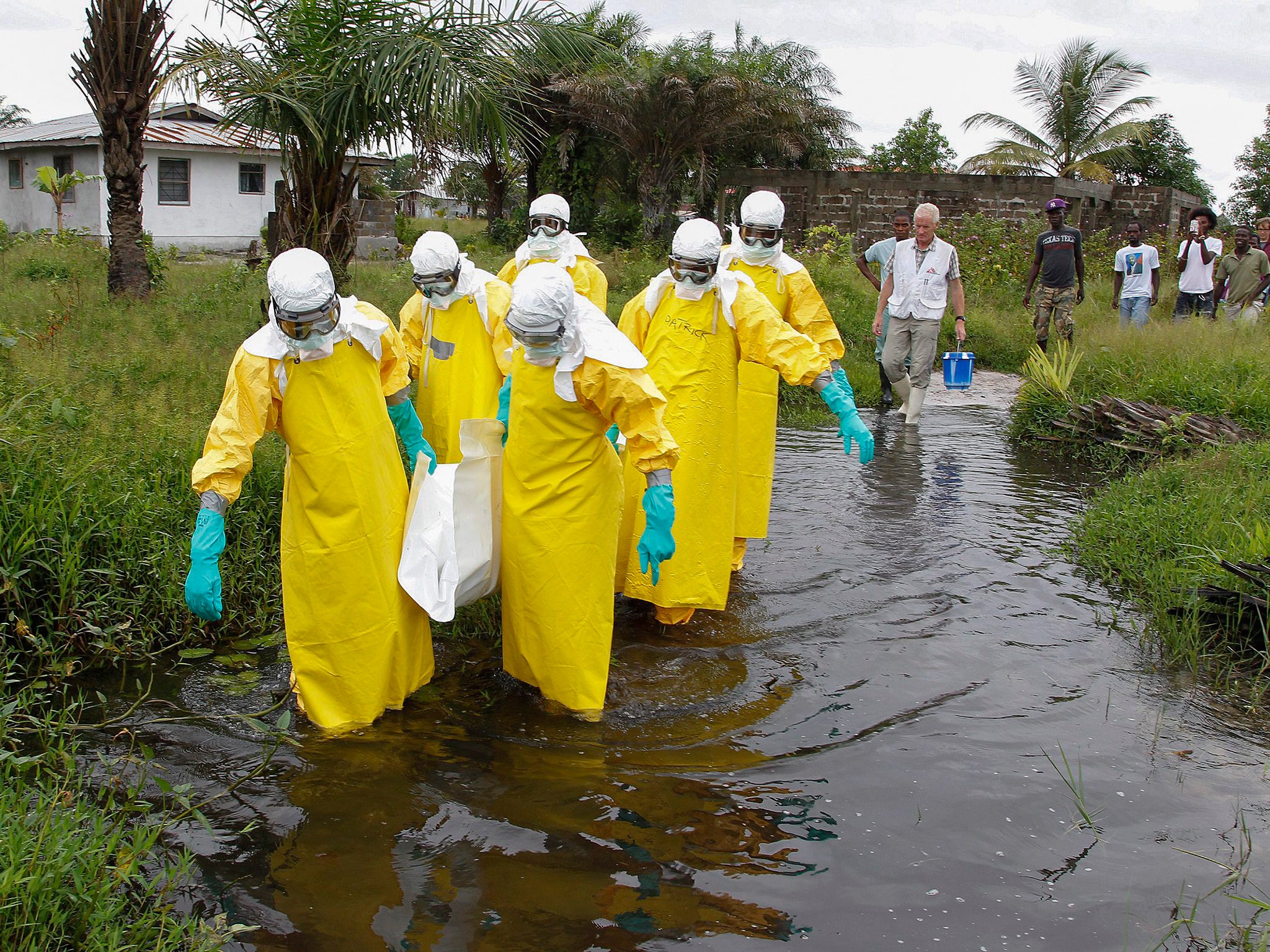 A Liberian burial squad carry the body of an Ebola victim in Marshall, Margini county, Liberia