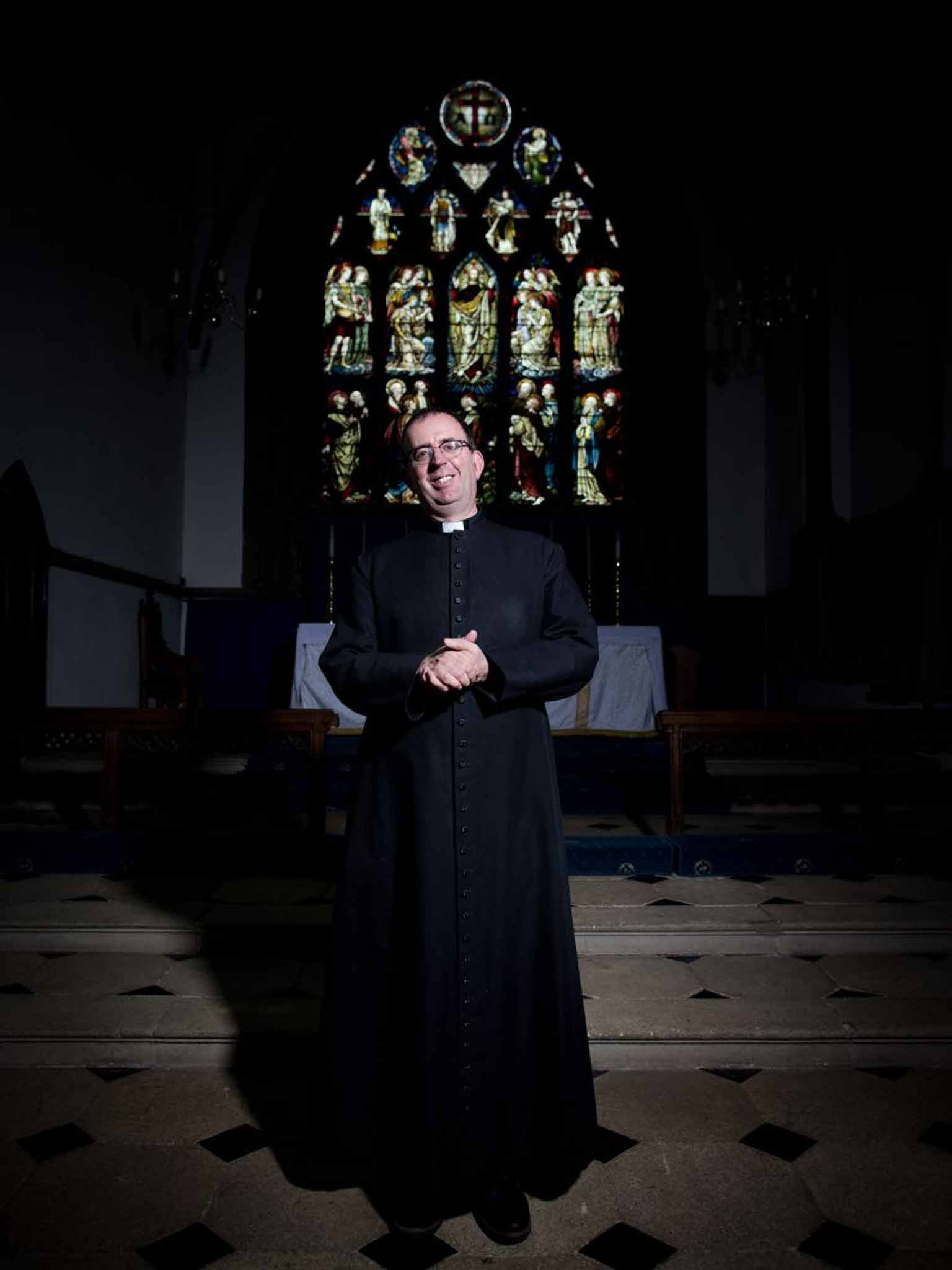 Service with a smile: Richard Coles in his church