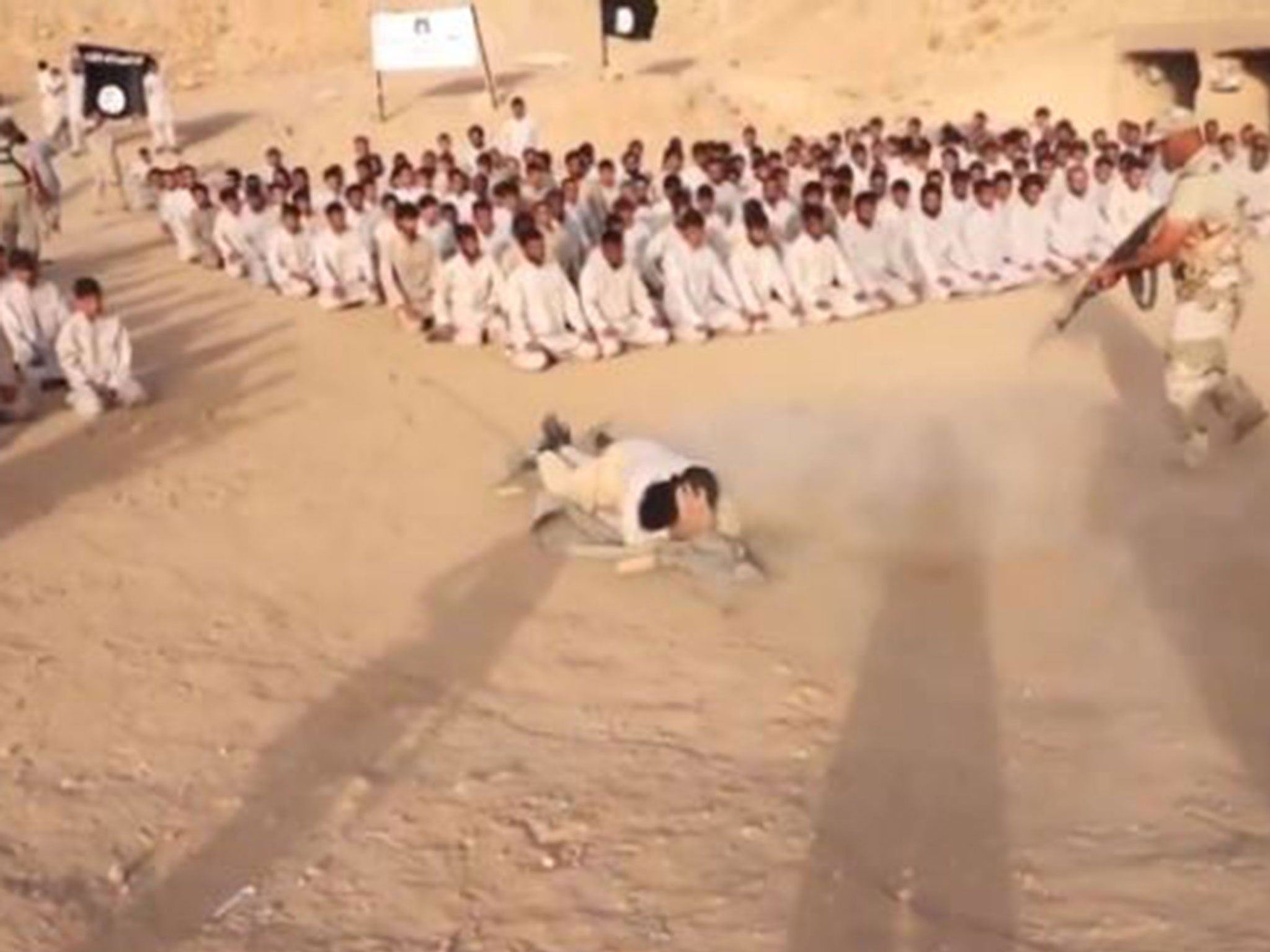 Isis recruits are shot at as they crawl on the ground during a training regime in a propaganda video purportedly filmed at a training camp in northern Iraq