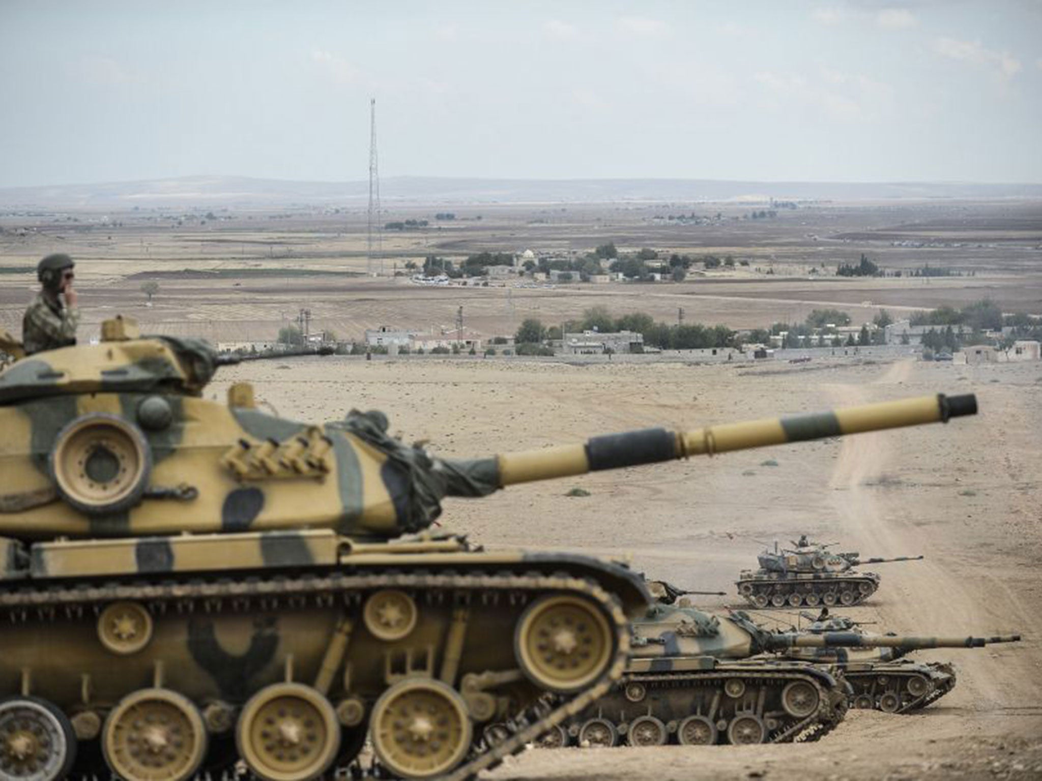 Turkish army tanks take position near the Syrian border at the end of last month
