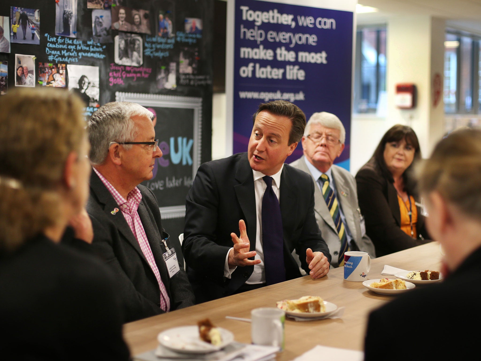 Prime Minister David Cameron talks to pensioners and older working people at Age UK headquarters on October 14, 2014 in London, England.